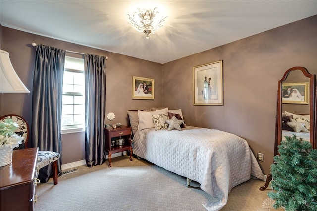 bedroom with light carpet, visible vents, and baseboards