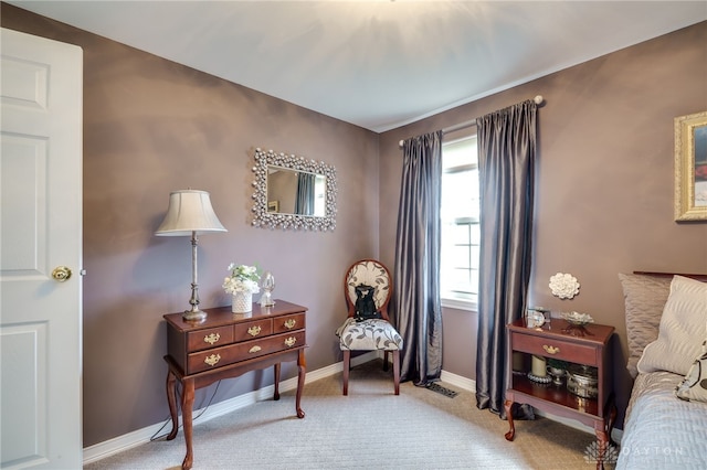 bedroom with light colored carpet and baseboards