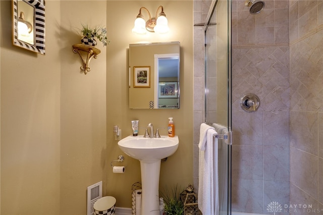 full bath featuring a stall shower, visible vents, and a sink