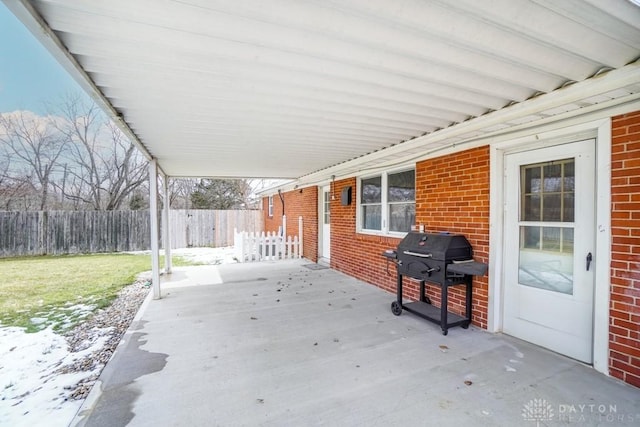 view of patio / terrace with a grill and fence