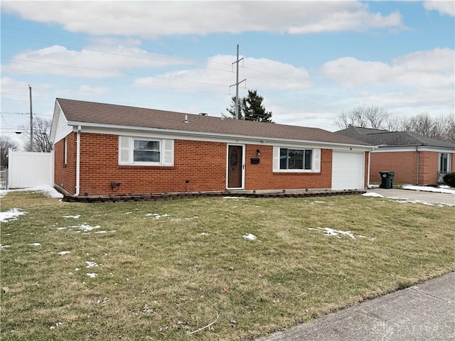 single story home featuring brick siding, concrete driveway, an attached garage, fence, and a front yard