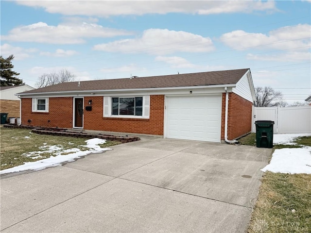 ranch-style house with a garage, brick siding, fence, driveway, and roof with shingles