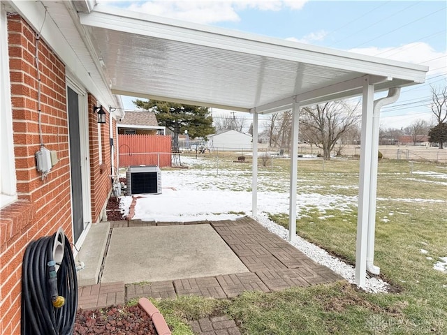 view of patio / terrace featuring central air condition unit and fence