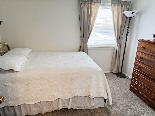 carpeted bedroom featuring baseboards