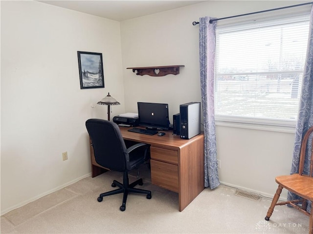 home office featuring baseboards, visible vents, and light colored carpet