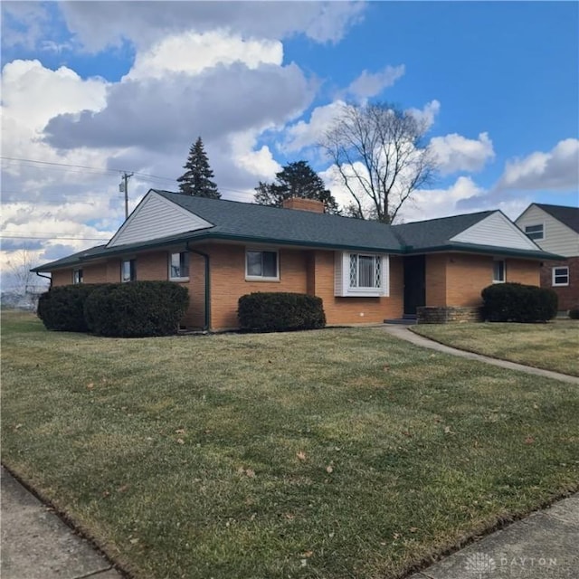 single story home featuring brick siding and a front yard