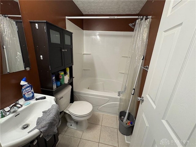 full bathroom with a textured ceiling, tile patterned flooring, toilet, a sink, and shower / bath combo with shower curtain