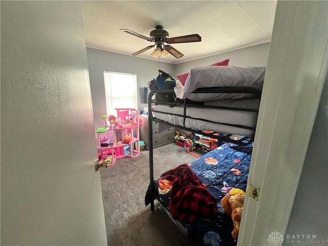 bedroom featuring ornamental molding, carpet, and a ceiling fan