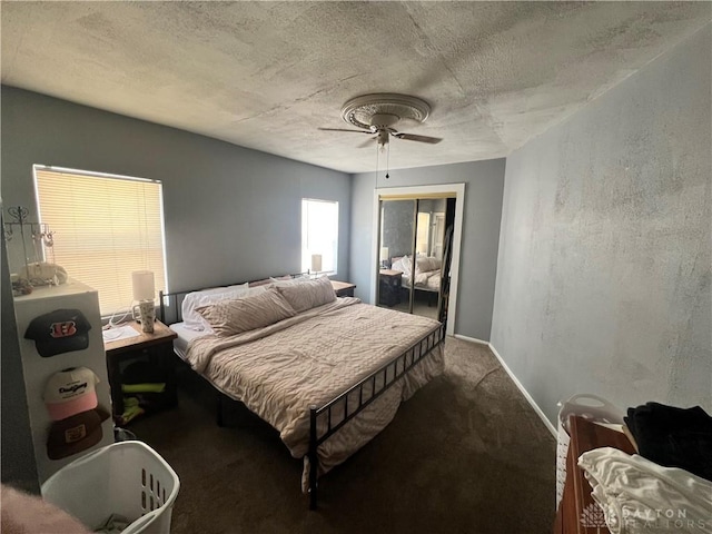 bedroom featuring carpet, a closet, a ceiling fan, a textured ceiling, and baseboards