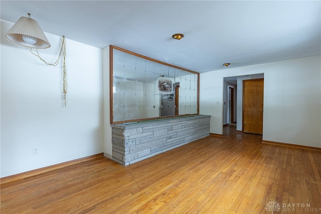 unfurnished living room featuring wood finished floors