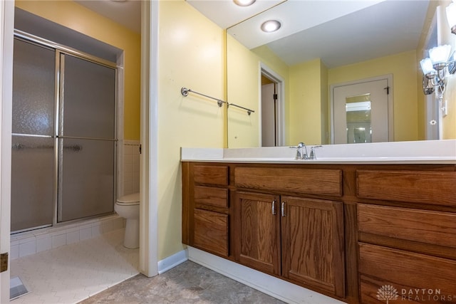 full bath with toilet, a stall shower, tile patterned flooring, and vanity