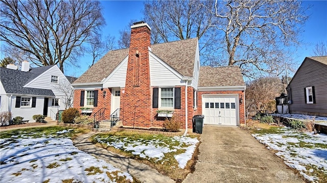 view of front of house with a garage, brick siding, concrete driveway, roof with shingles, and a chimney