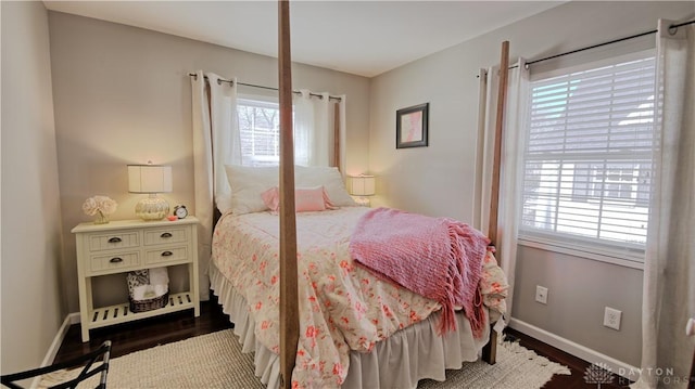 bedroom featuring baseboards and wood finished floors