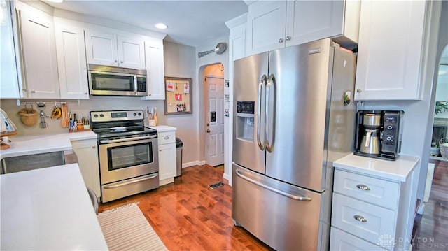 kitchen featuring a sink, appliances with stainless steel finishes, white cabinets, and light countertops