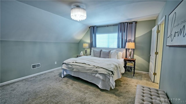 bedroom with lofted ceiling, carpet flooring, visible vents, and baseboards