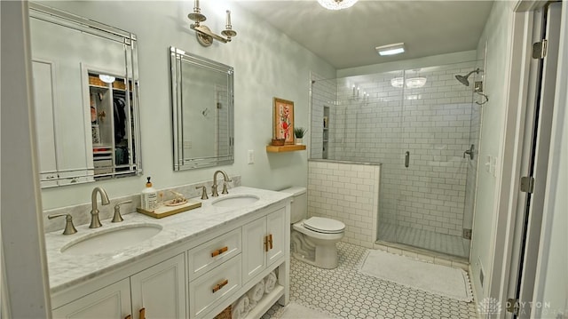 full bath featuring double vanity, a stall shower, tile patterned flooring, and a sink