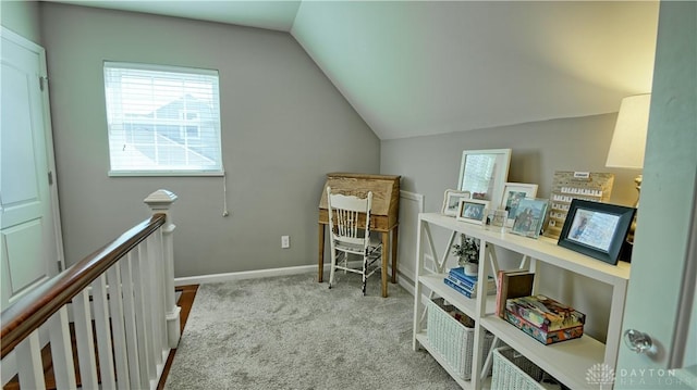 interior space featuring light carpet, lofted ceiling, and baseboards