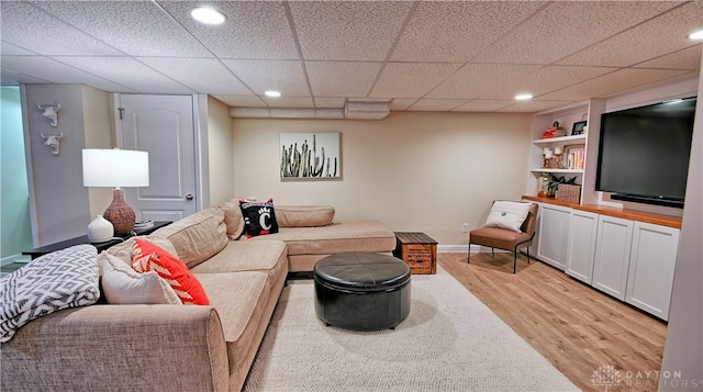 living room with light wood finished floors, recessed lighting, and baseboards