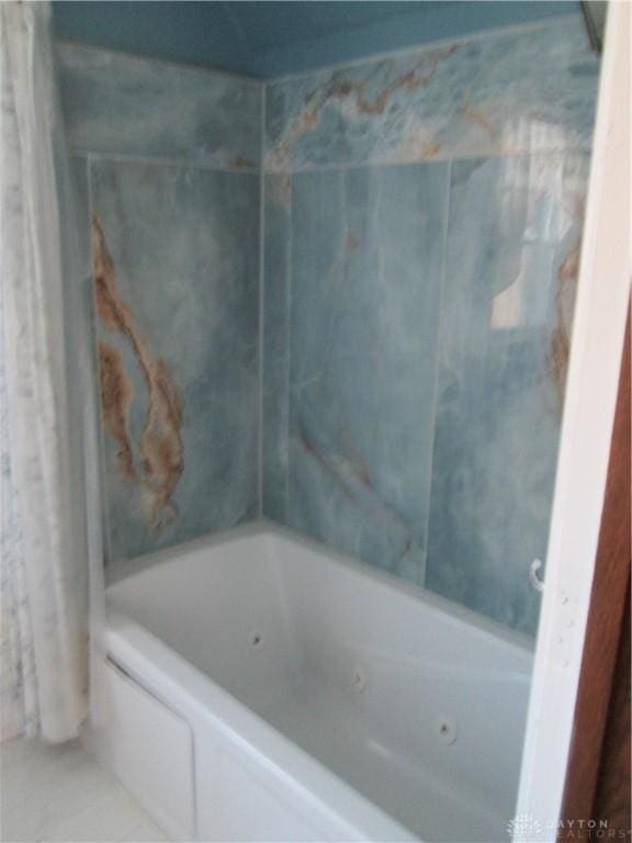 full bathroom featuring tile patterned flooring and shower / bathtub combination with curtain