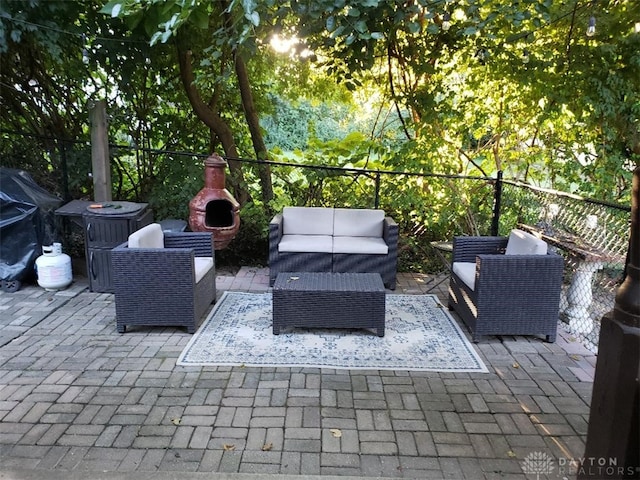 view of patio featuring an outdoor living space with a fireplace