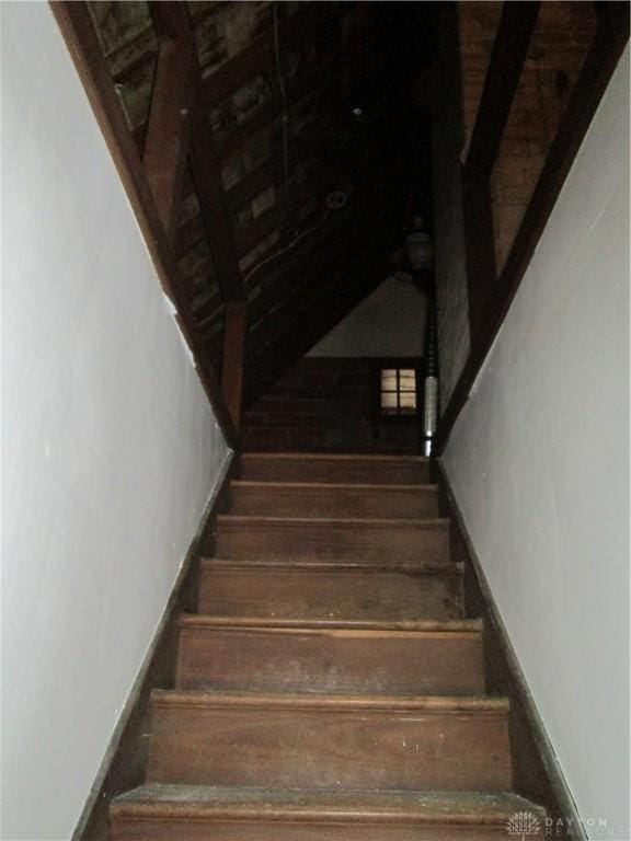 stairs featuring wood finished floors