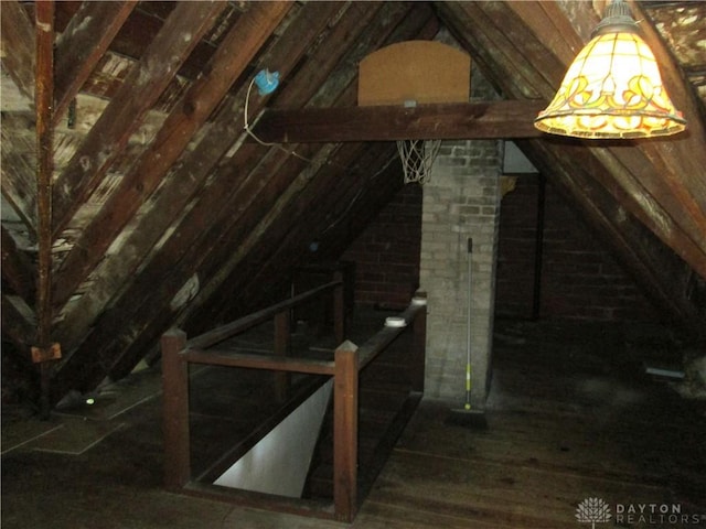 unfinished attic featuring an upstairs landing