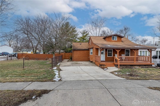 view of front of property featuring a front yard, covered porch, and fence