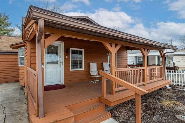 wooden terrace featuring fence