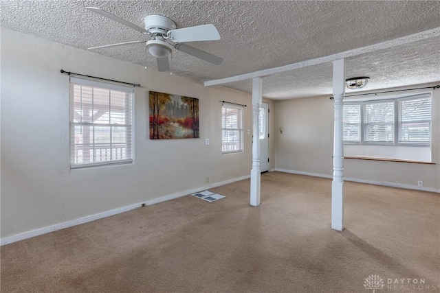 interior space with carpet flooring, plenty of natural light, and baseboards