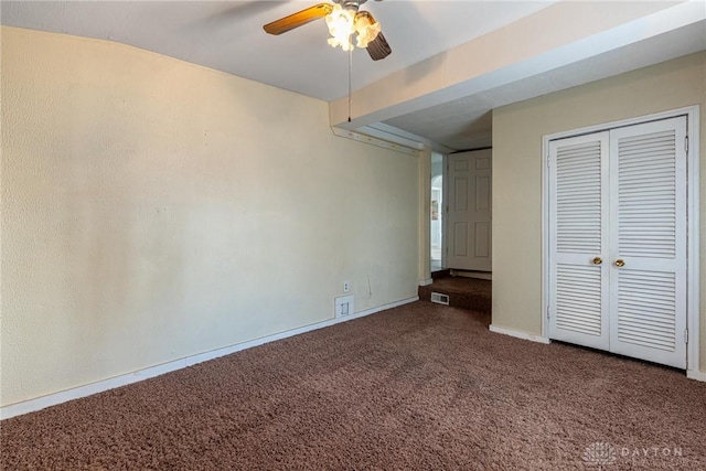 unfurnished bedroom featuring ceiling fan, carpet flooring, visible vents, baseboards, and a closet