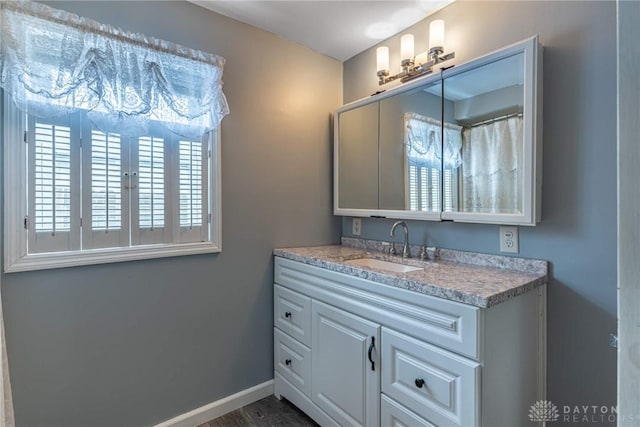 bathroom with vanity and baseboards