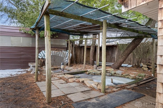 view of patio with fence and an outdoor structure