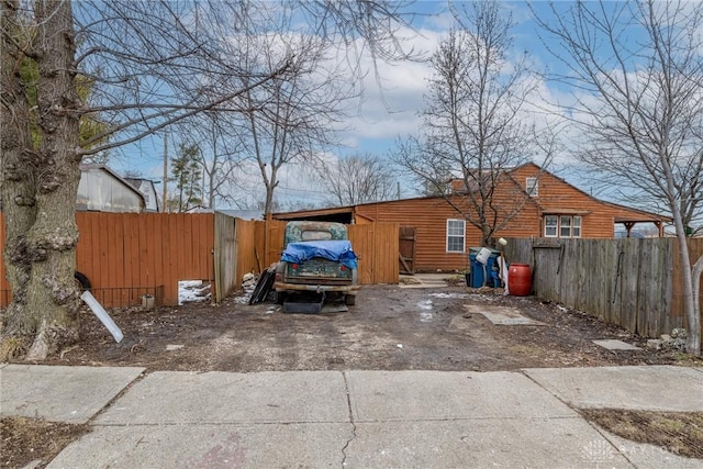 exterior space featuring driveway and fence