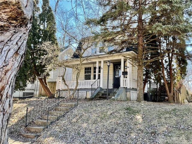 view of front facade featuring central air condition unit and covered porch