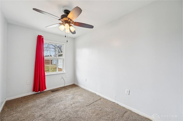 carpeted empty room featuring visible vents, a ceiling fan, and baseboards