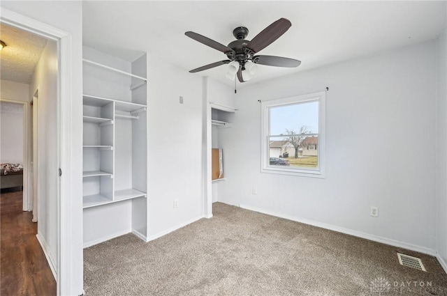 unfurnished bedroom with carpet, visible vents, ceiling fan, and baseboards