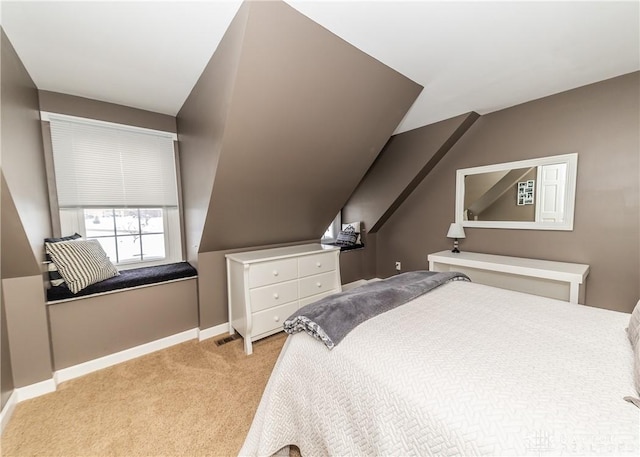 carpeted bedroom featuring lofted ceiling, visible vents, and baseboards