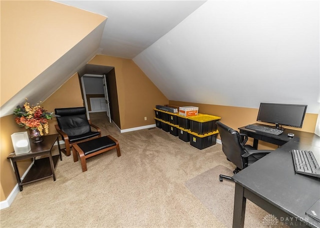 home office featuring lofted ceiling, carpet flooring, and baseboards