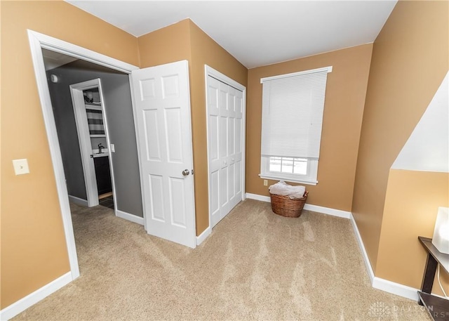 hall with carpet and baseboards