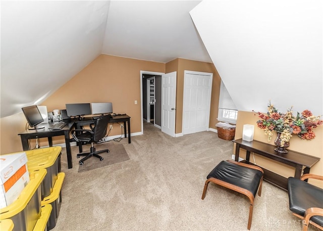 office space with lofted ceiling, baseboards, and carpet flooring