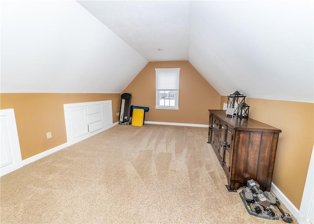 additional living space with carpet flooring, vaulted ceiling, and baseboards