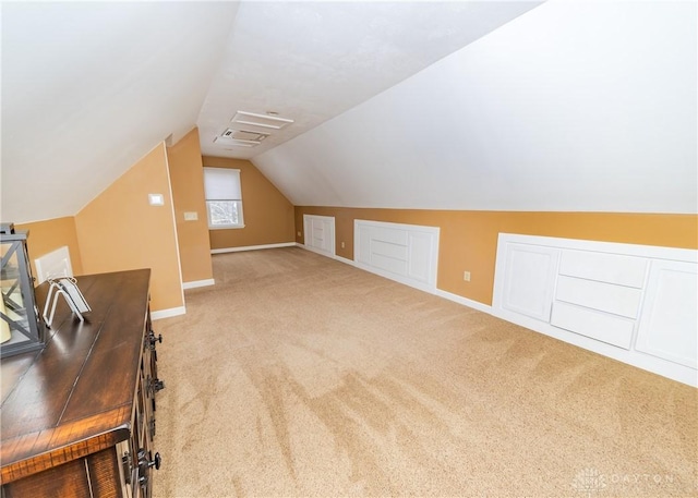 bonus room featuring light carpet, baseboards, and vaulted ceiling