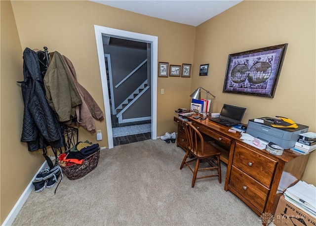 carpeted office space featuring baseboards