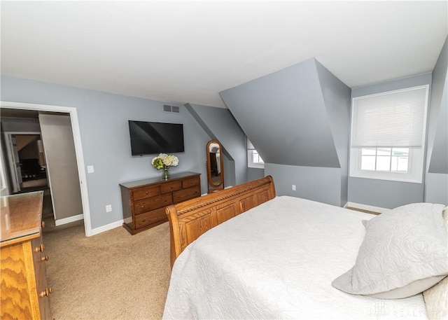 bedroom featuring lofted ceiling, visible vents, light carpet, and baseboards