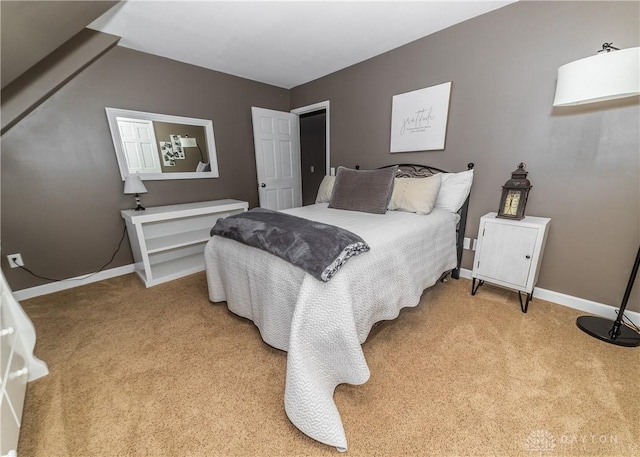 bedroom with light carpet and baseboards