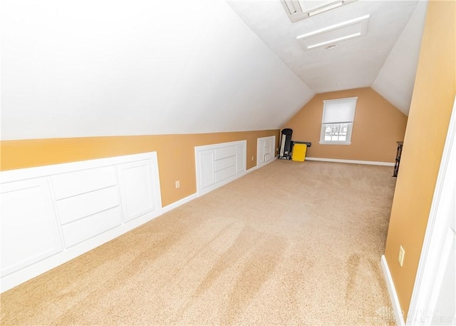 additional living space featuring vaulted ceiling, carpet, and baseboards