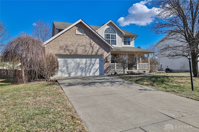 traditional-style home featuring a garage, driveway, covered porch, a front lawn, and brick siding