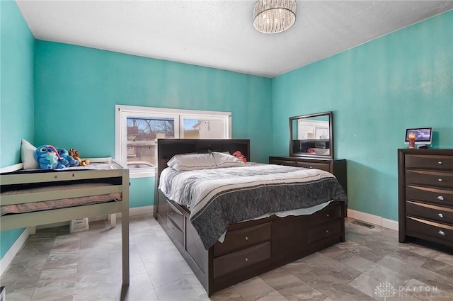 bedroom featuring a chandelier, visible vents, and baseboards