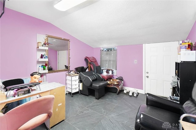 living area with lofted ceiling and a textured ceiling