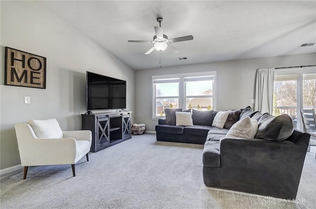 carpeted living room with a ceiling fan, lofted ceiling, visible vents, and baseboards